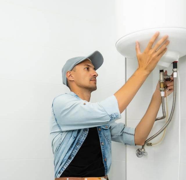 Plumber working on a tankless water heater