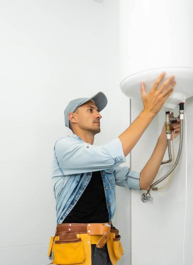 Plumber working on a tankless water heater
